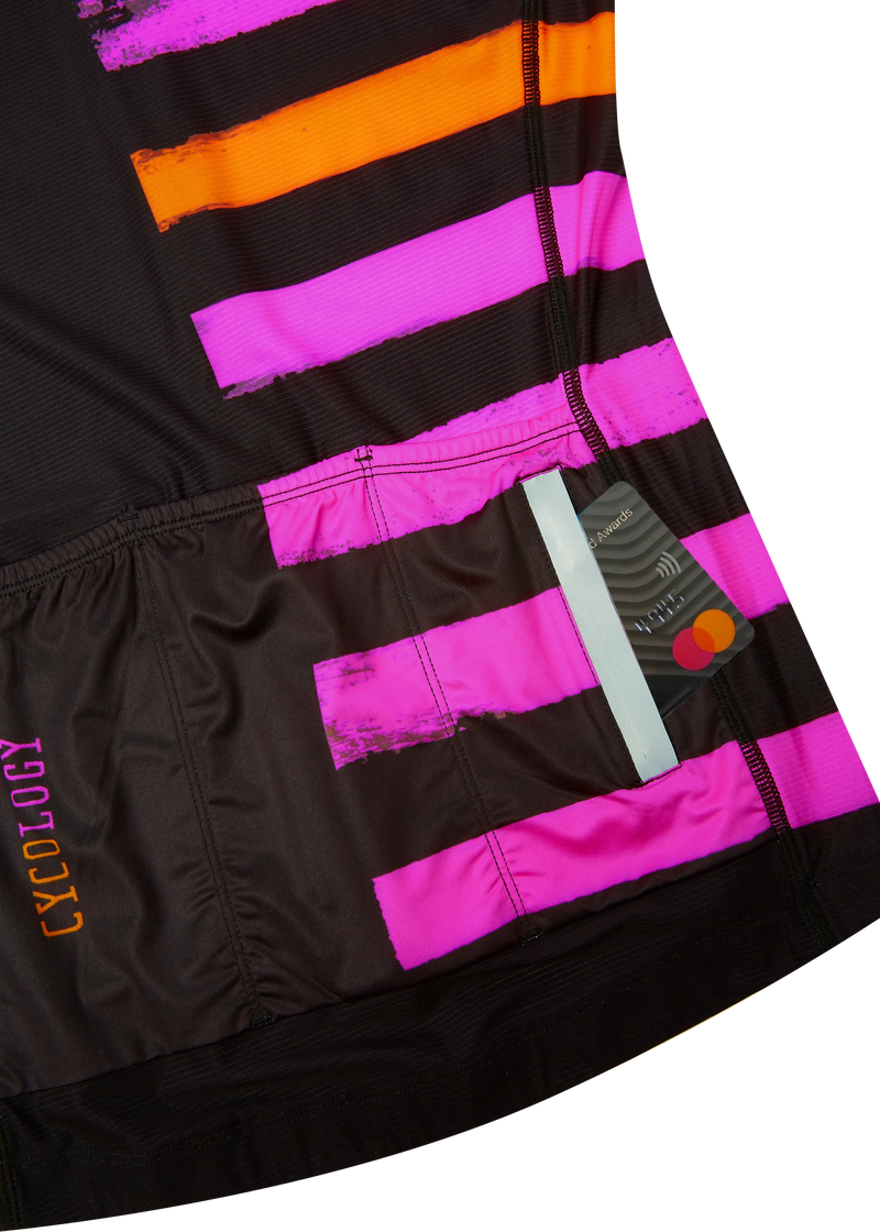 Close-up of a black, pink, and orange striped shorts with 'Cycology' branding.