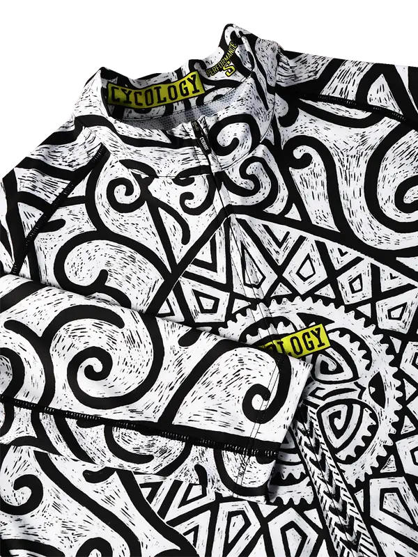 Close-up of a Zanzibar Men's White Long Sleeve Summer Cycling Jersey
shirt with black and white geometric pattern and 'Cycology' branding.